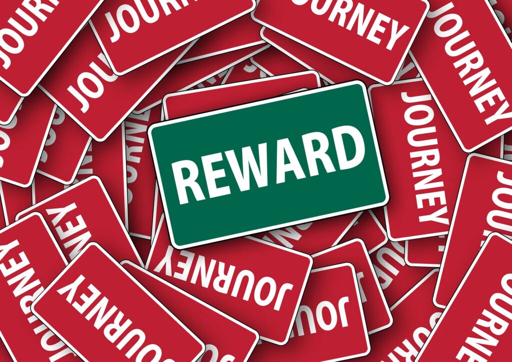 Green REWARD sign among red JOURNEY signs
